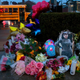 A photo of Alexandria Bell rests at the scene of a growing floral memorial to the victims of a school shooting at Central Visual & Performing Arts High School, Tuesday, Oct. 25, 2022, in St. Louis. Bell and teacher Jean Kuczka were killed, along with the gunman, in Monday’s shooting.